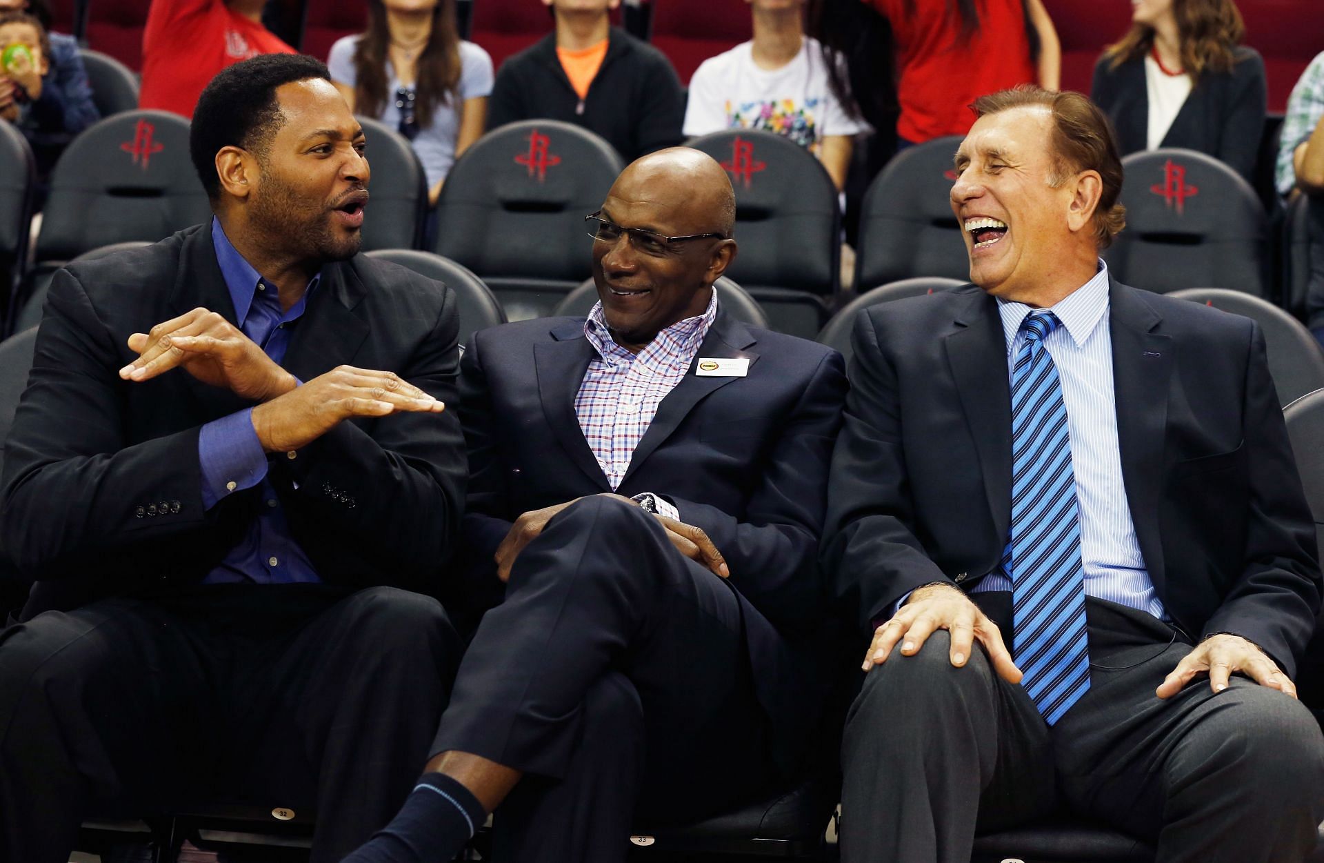 Fomer Houston Rockets Robert Horry and Clyde Drexler share a laugh with former coach Rudy Tomjanovich as the team honors the 20th anniversary of back-to-back championships during their their game against the Denver Nuggets at the Toyota Center on March 19, 2015 in Houston, Texas.