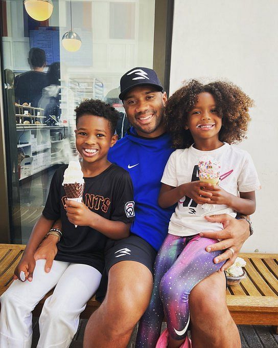 Denver Broncos quarterback Russell Wilson (3) greets, from left to right,  his daughter Sienna, wife and rap star Ciara, and sons Future and Win  before taking part in drills during the NFL