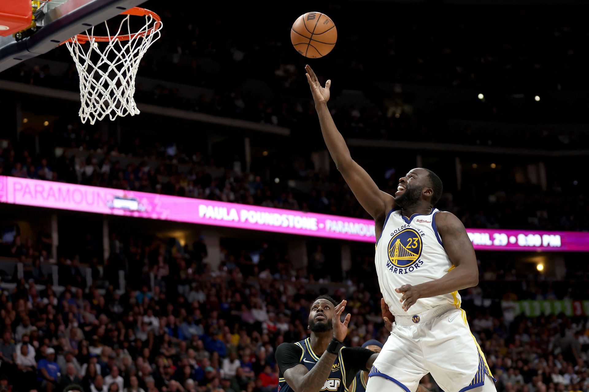 Draymond Green #23 of the Golden State Warriors goes to the basket against Will Barton #5 of the Denver Nuggets in the fourth quarter during Game 4 of the Western Conference First Round NBA Playoffs at Ball Arena on April 24, 2022, in Denver, Colorado .