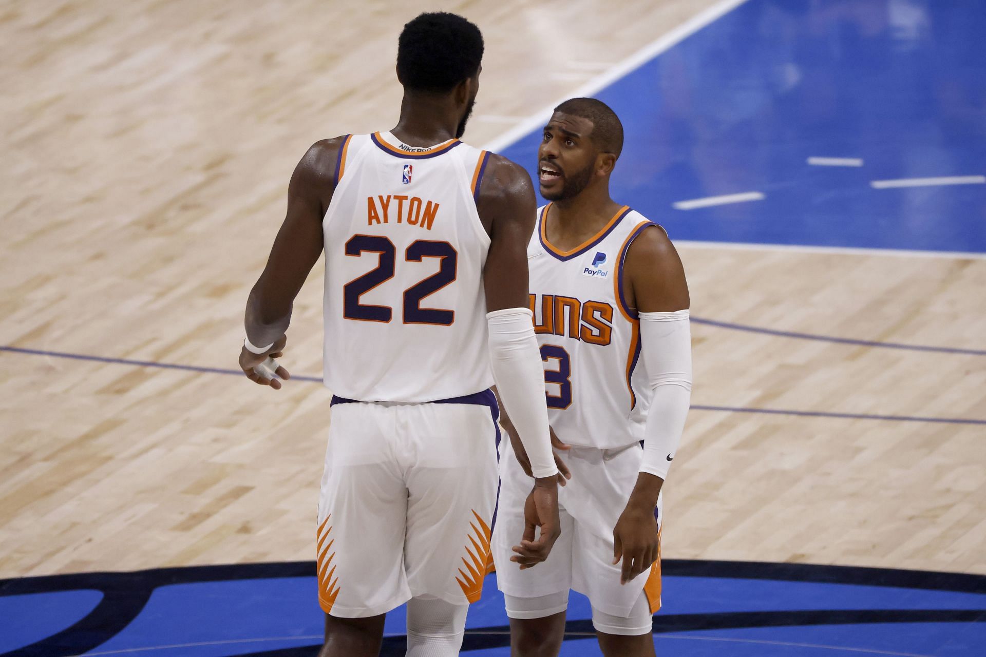 Chris Paul of the Phoenix Suns talks with Deandre Ayton.