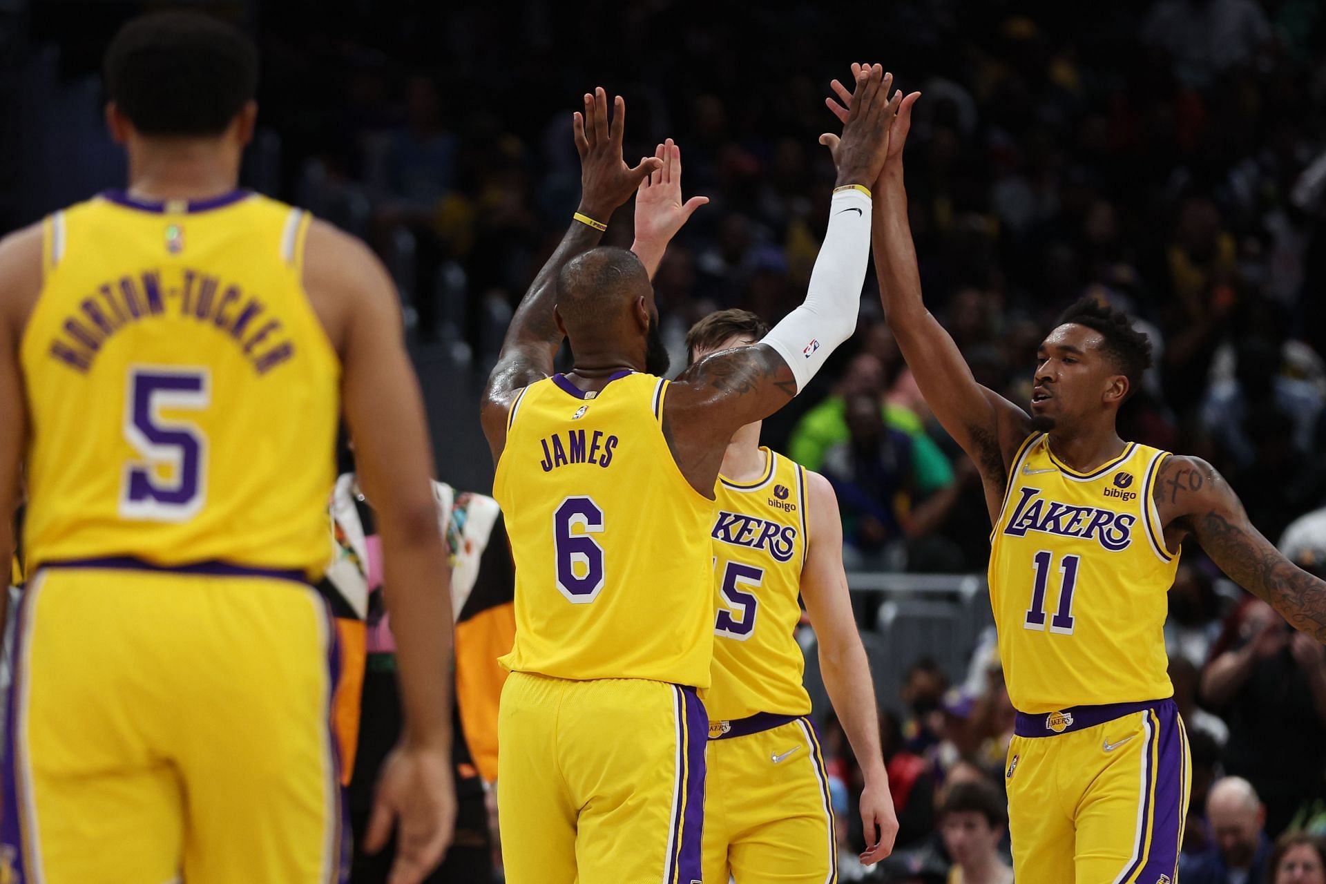 LeBron James of the LA Lakers high-fives his teammates.
