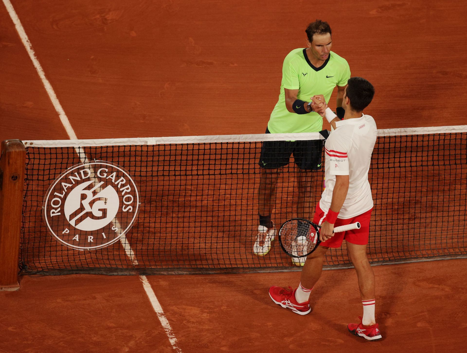 Rafael Nadal and Novak Djokovic shake hands after their 2021 French Open clash