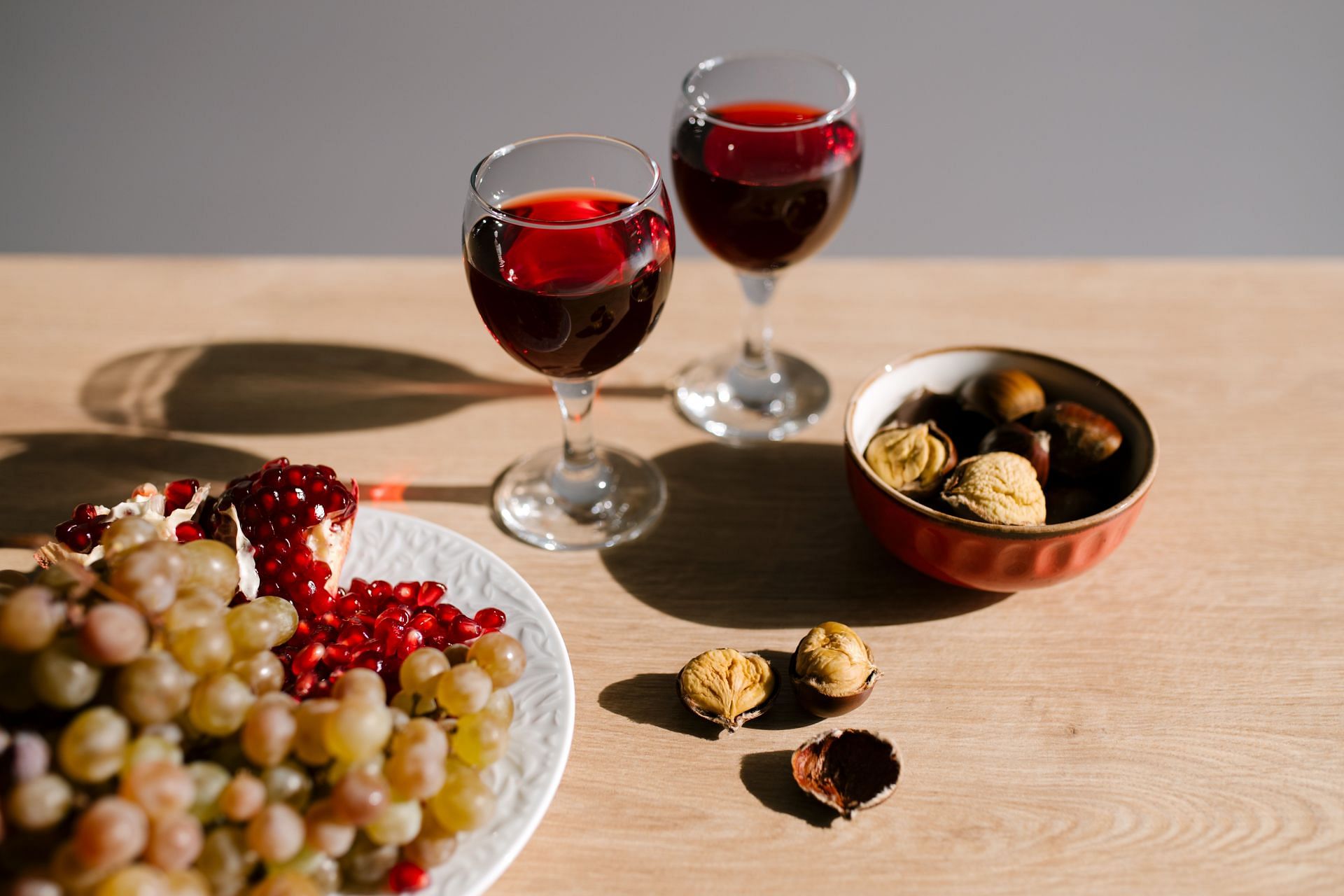 Red wine is made by fermenting dark colored grapes with their skins (Image via Pexels/Julia Volk)