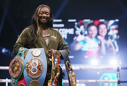 Claressa Shields with her WBA, WBC and IBF women's middleweight belts.