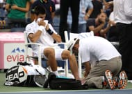 Novak Djokovic receives treatment at the 2011 US Open