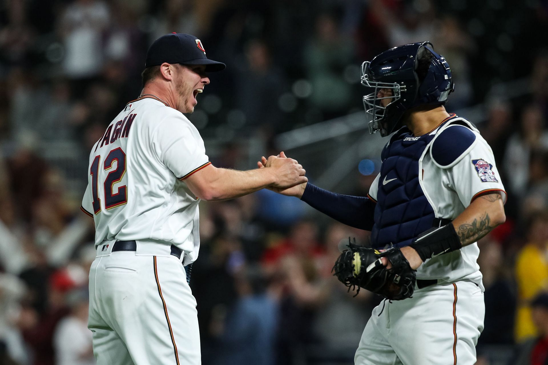 Emilio Pagan and Gary Sanchez of the Minnesota Twins celebrate a 2-1 victory.