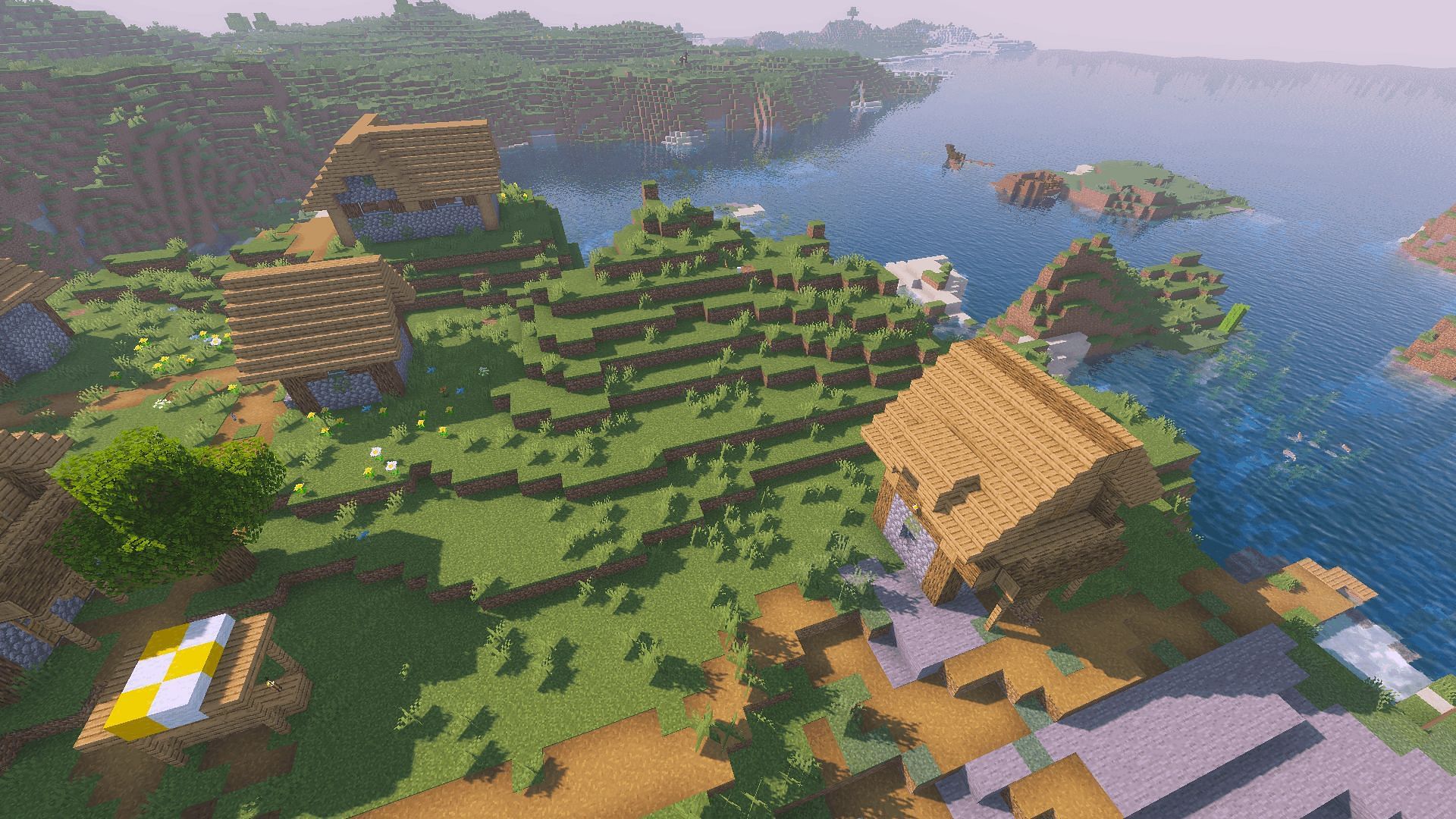 A coastal village with the KUDA shader (Image via Minecraft)