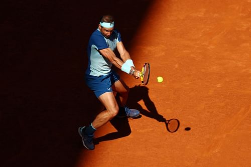 Rafael Nadal strikes a backhand in his third-round match against David Goffin in Madrid.