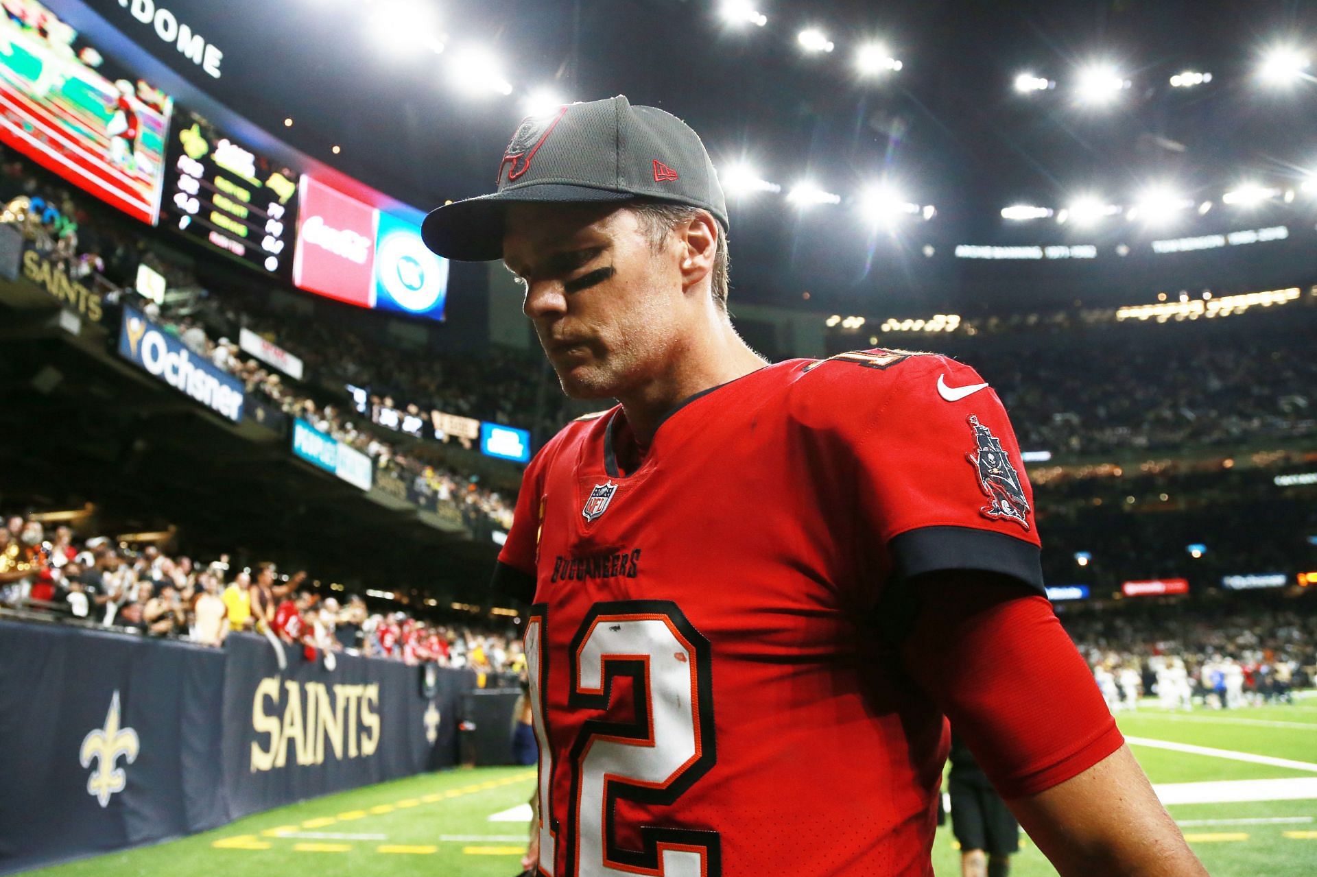 Tom Brady walks off the field after tasting defeat at the hands of the New Orleans Saints