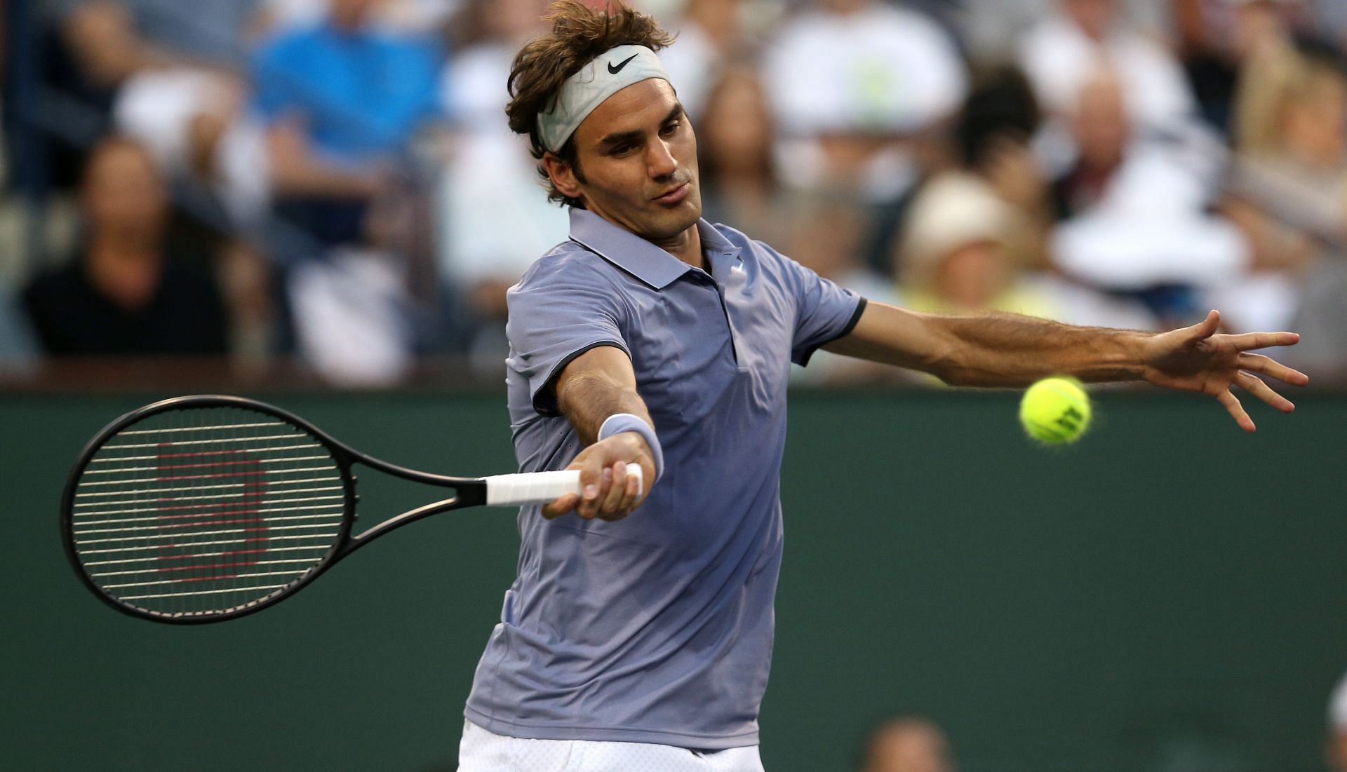 Roger Federer hits a return to Tommy Haas of Germany during the BNP Paribas Open at Indian Wells