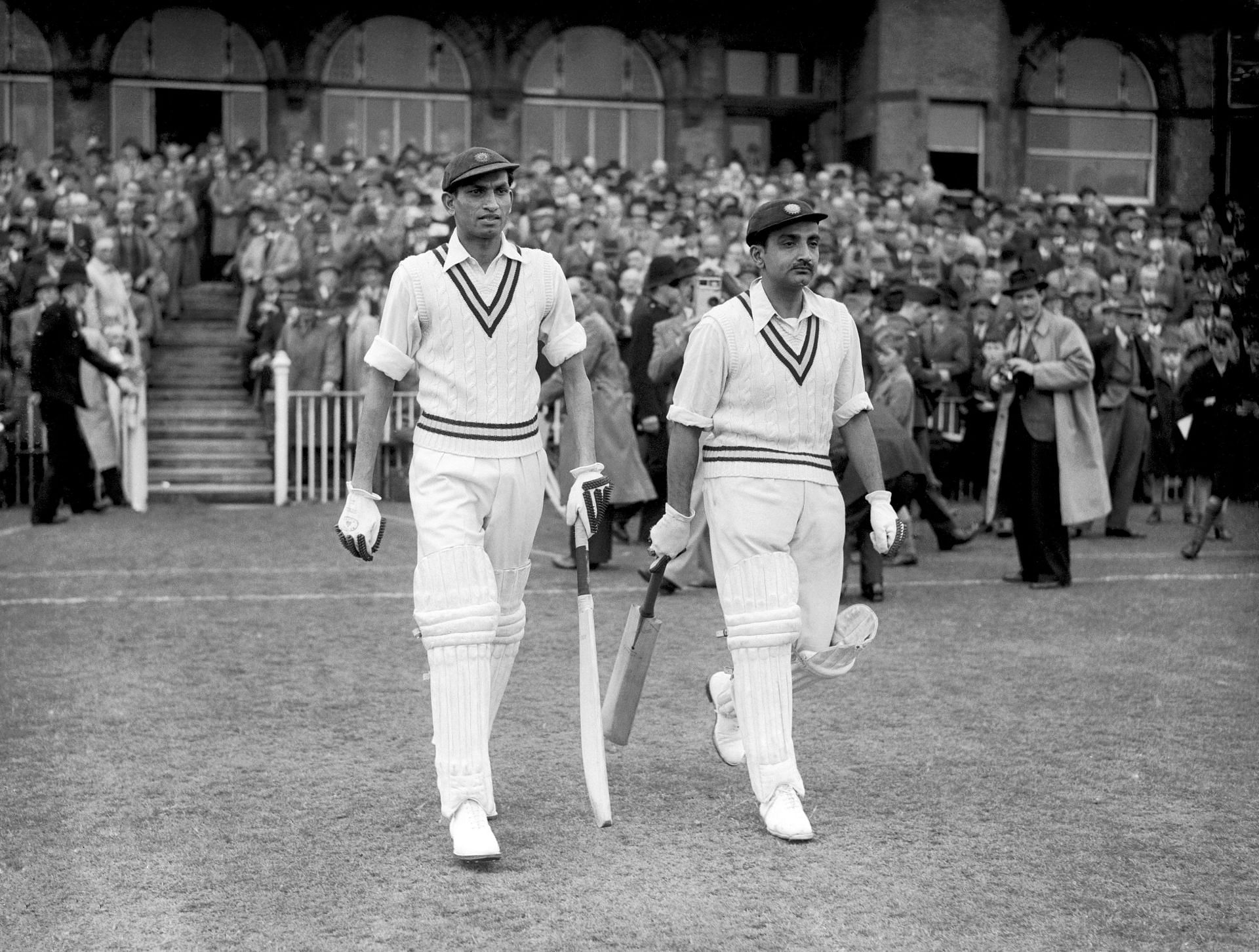 Vijay Merchant (right) walking out to open with Mushtaq Ali. Merchant&rsquo;s all-time first-class career average of 71.64 per innings is second only to Sir Donald Bradman&rsquo;s monumental 95.14.
