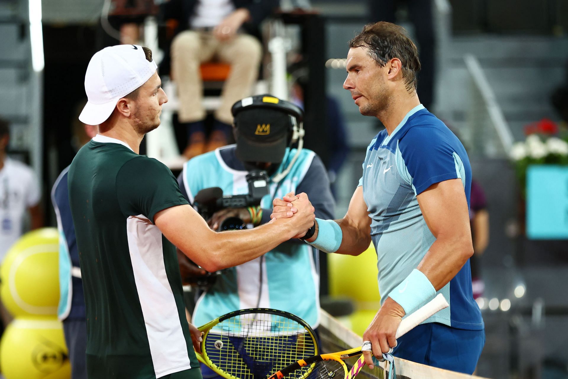 Rafael Nadal and Miomir Kecmanovic interact following their third round match