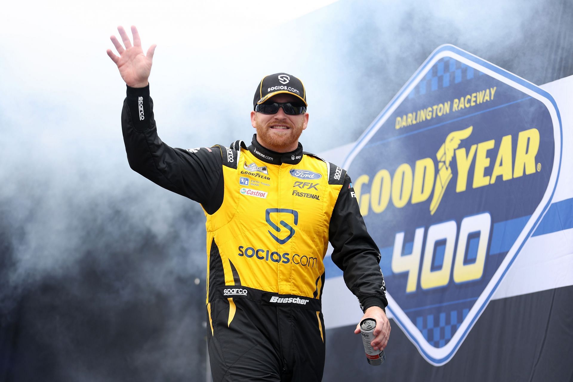 Chris Buescher waves to fans as he walks on stage during driver intros before the NASCAR Cup Series Goodyear 400 at Darlington Raceway