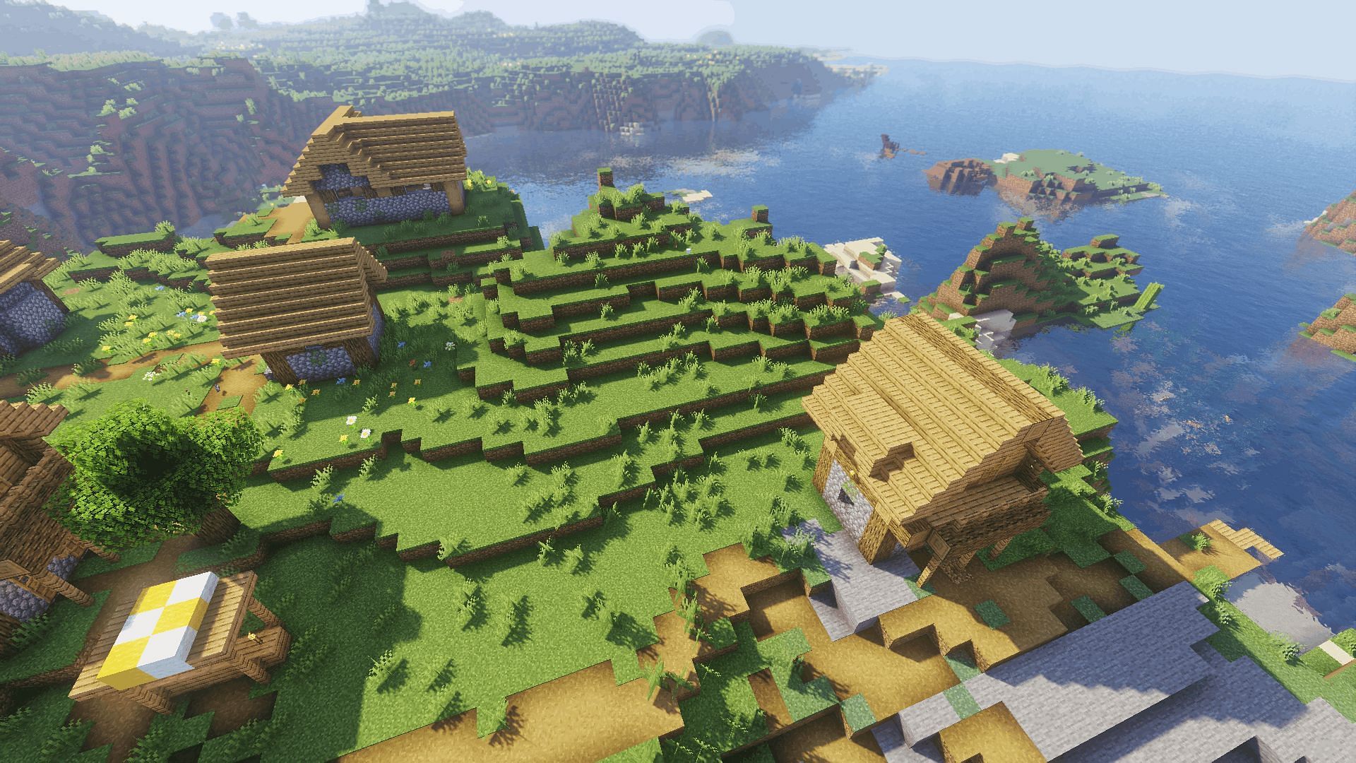 A coastal village with the Too Many Effects shader (Image via Minecraft)