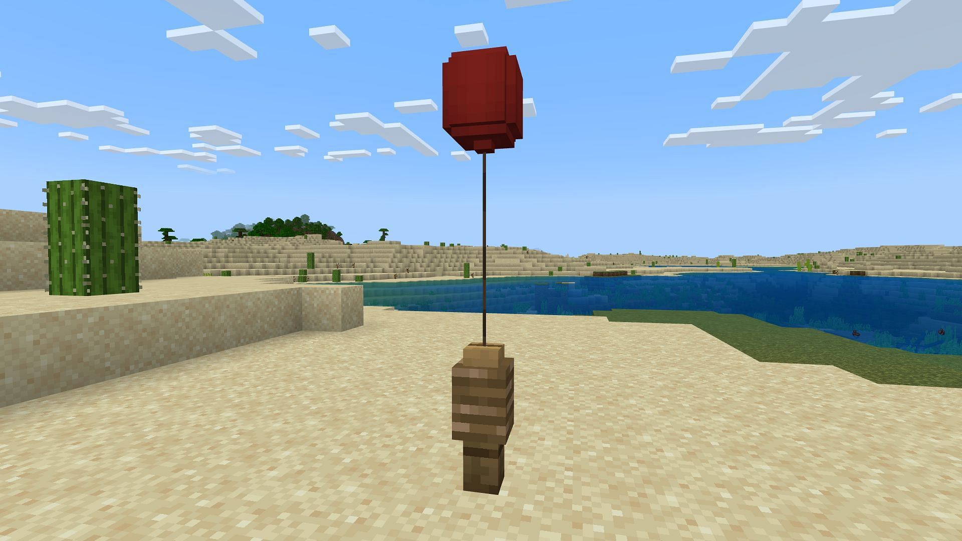 A red balloon on a lead tied to a fence (Image via Minecraft)