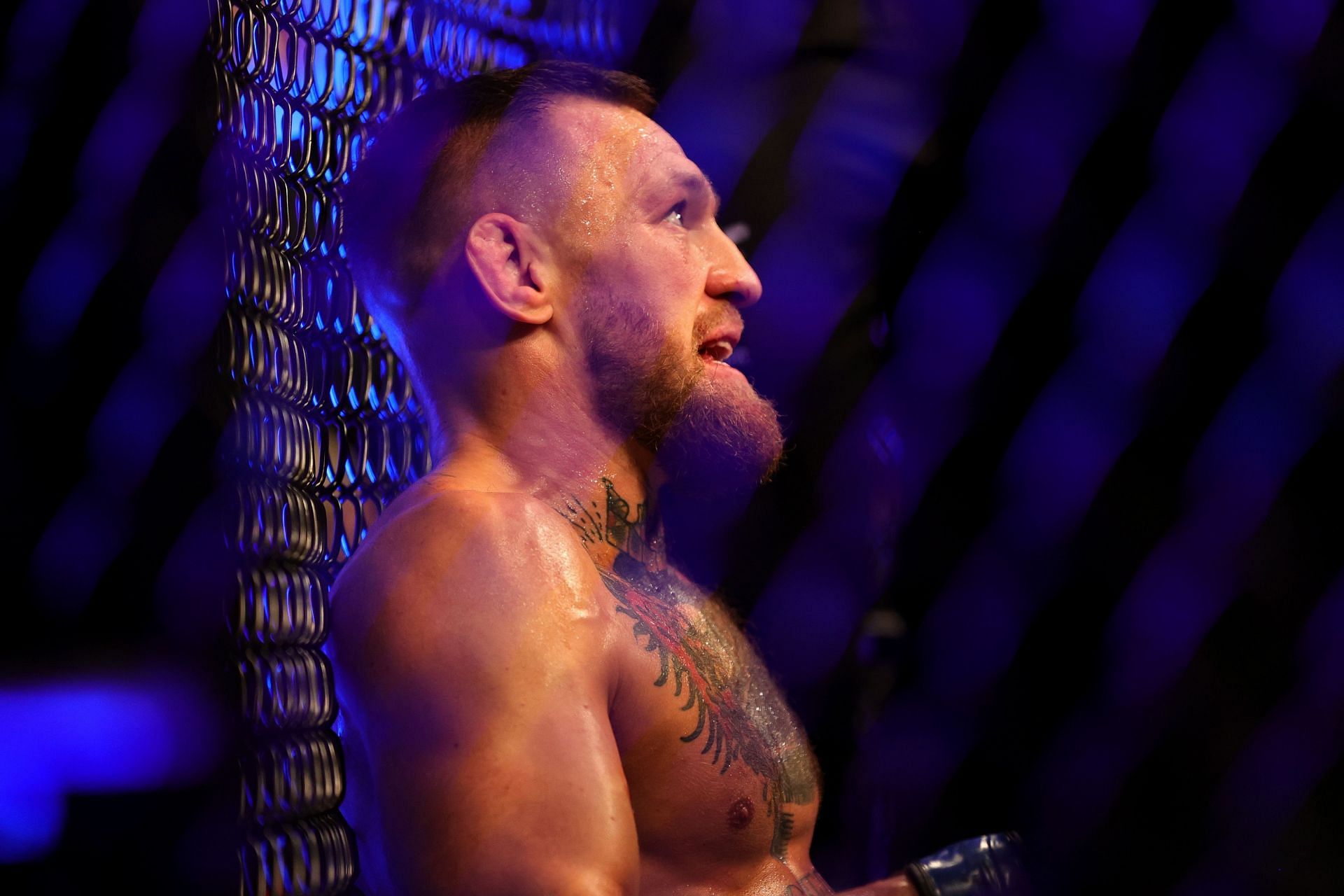 Conor McGregor awaits medical attention after his bout at UFC 264