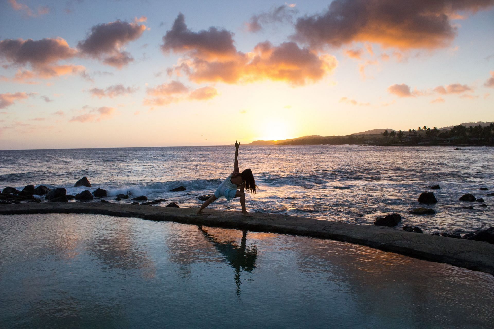 Revolved Triangle pose emphasizes your hips, back, shoulders, and legs (Image via Unsplash/Kristopher Allison)