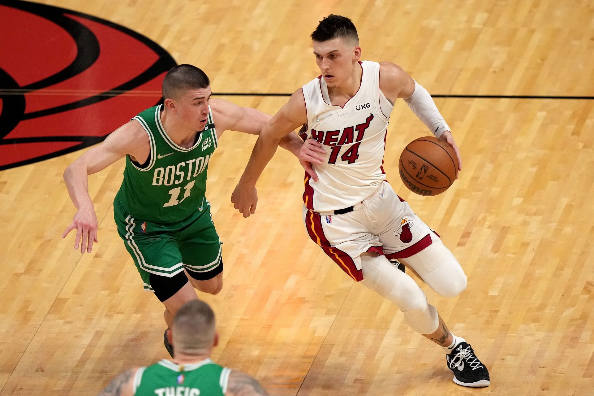 Tyler Herro #14 of the Miami Heat drives to the basket against Payton Pritchard #11 of the Boston Celtics