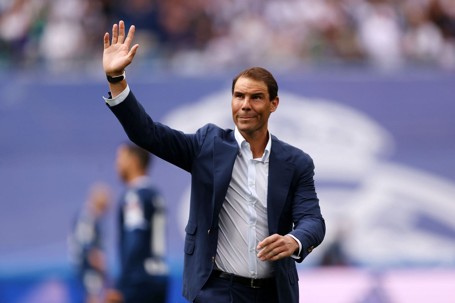 Rafael Nadal acknowledges the fans after taking the honorary kick-off prior to a Real Madrid CF match