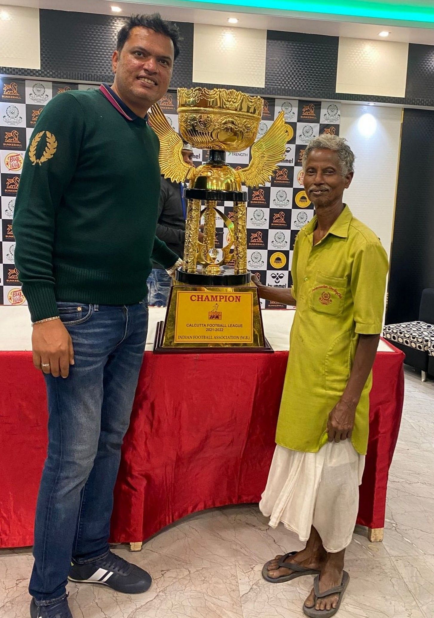 Dipak Kumar Singh (left) with the CFL Premier Division A trophy at the Mohammedan Sporting Club tent. Image: Twitter