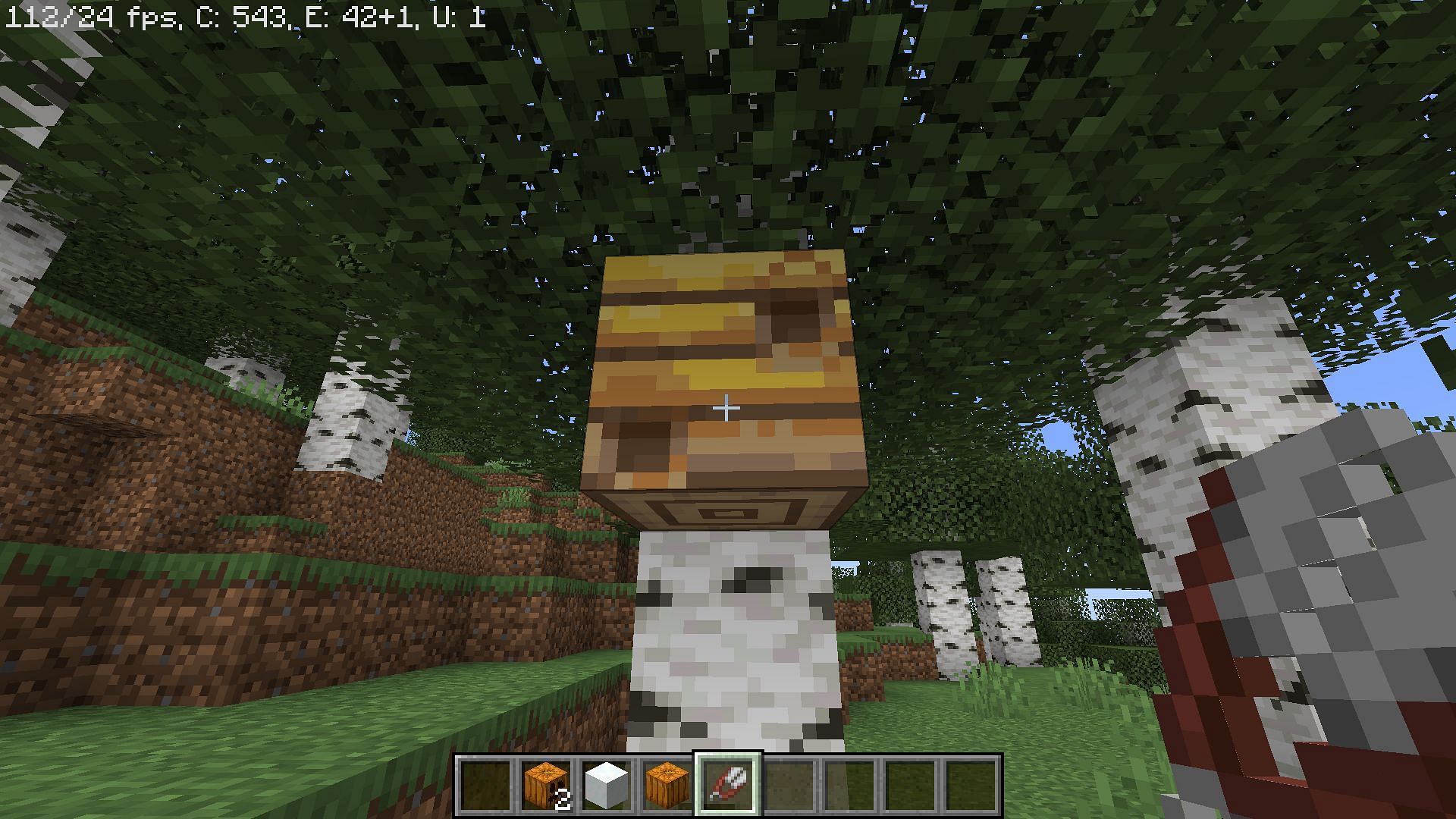 Obtain honeycomb from a beehive (Image via Minecraft)