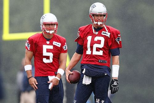 Tim Tebow (No. 5) and Tom Brady (No. 12) in 2013; New England Patriots Training Camp