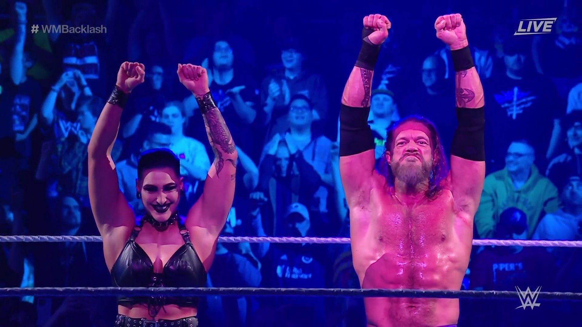 Edge with new associate Rhea Ripley after defeating AJ Styles!