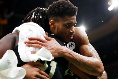 Giannis Antetokounmpo #34 hugs Jrue Holiday #21 of the Milwaukee Bucks