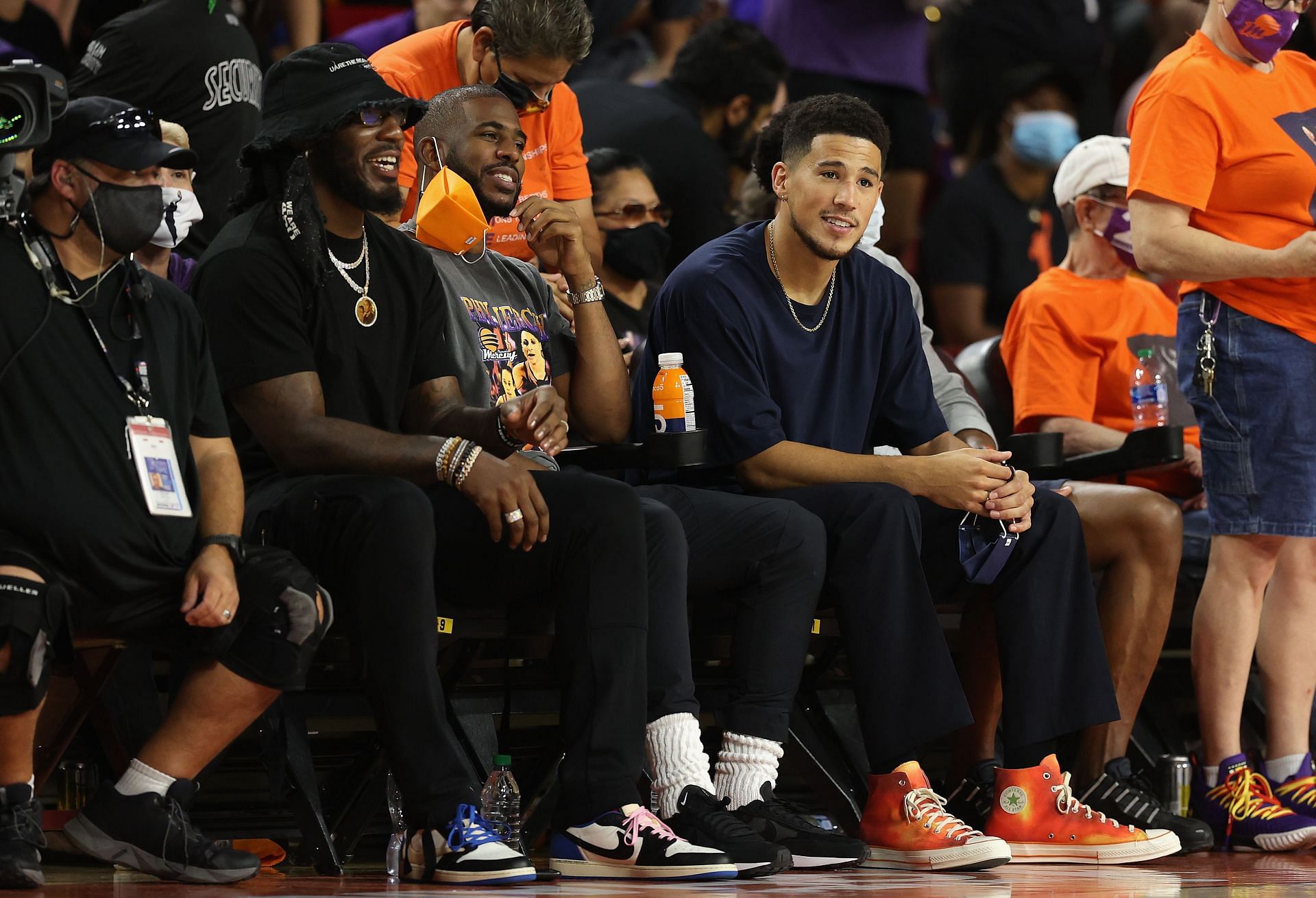 Chris Paul alongside Devin Booker and Jae Crowder at the 2021 WNBA Semifinals.