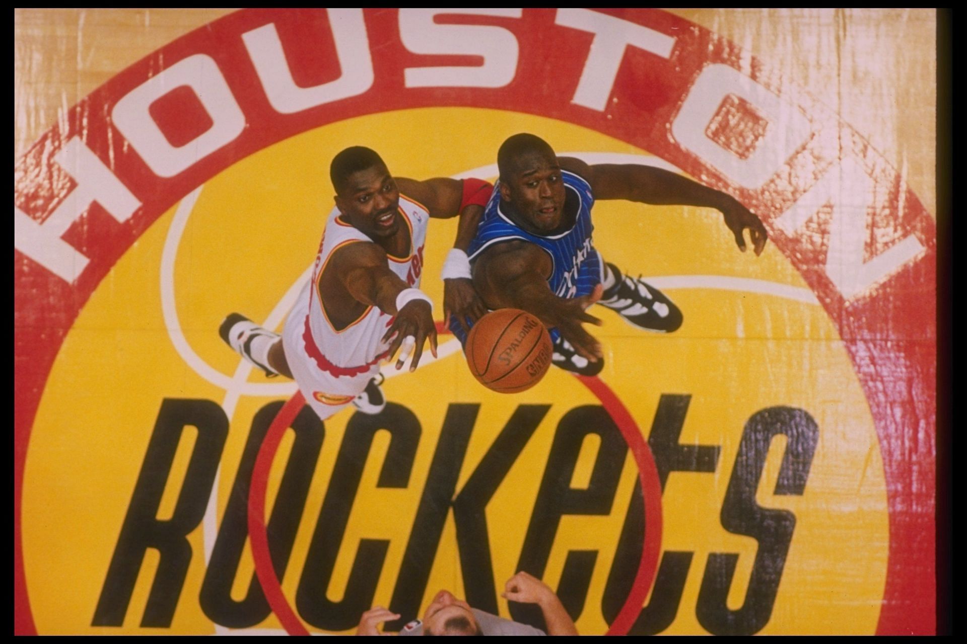 Shaquille O&#039;Neal and Hakeem Olajuwon compete at the tip-off