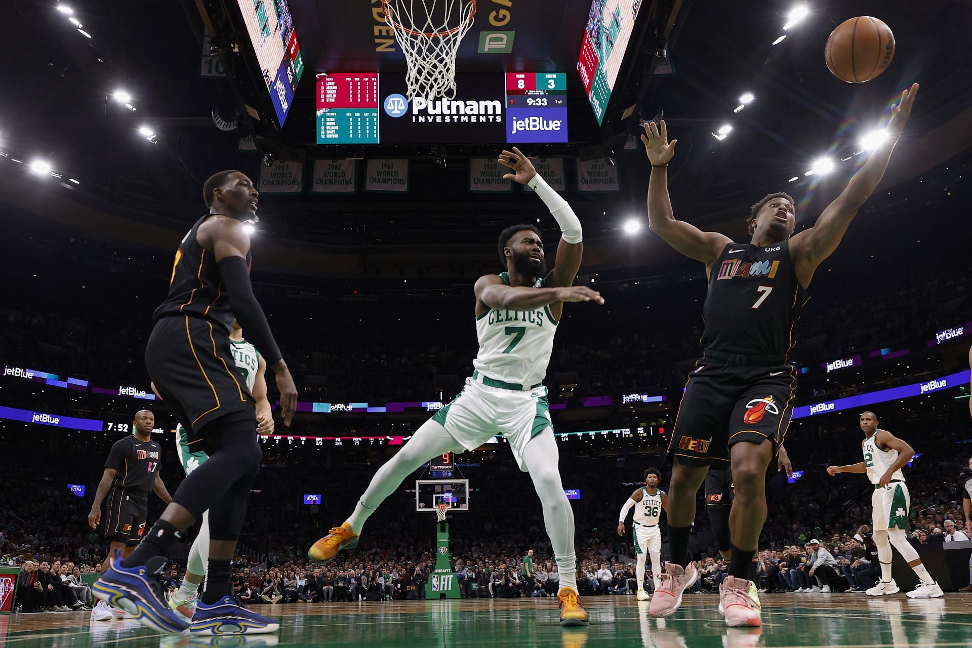 Kyle Lowry #7 of the Miami Heat grabs a rebound next to Jaylen Brown #7 of the Boston Celtics