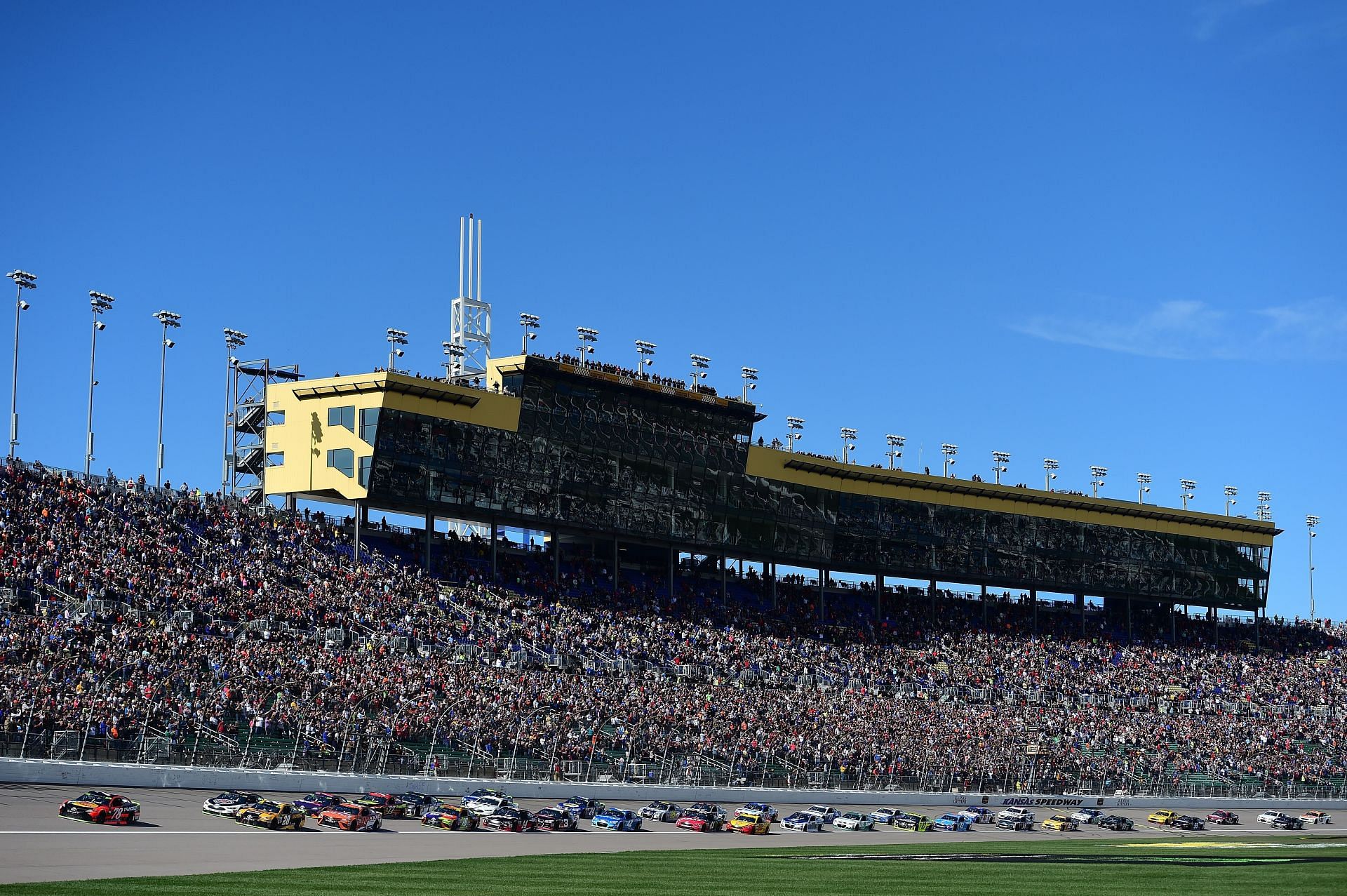 Martin Truex Jr. leads the field towards turn one after taking the green flag to start the Monster Energy NASCAR Cup Series Hollywood Casino 400 at Kansas Speedway (Photo by Jared C. Tilton/Getty Images)