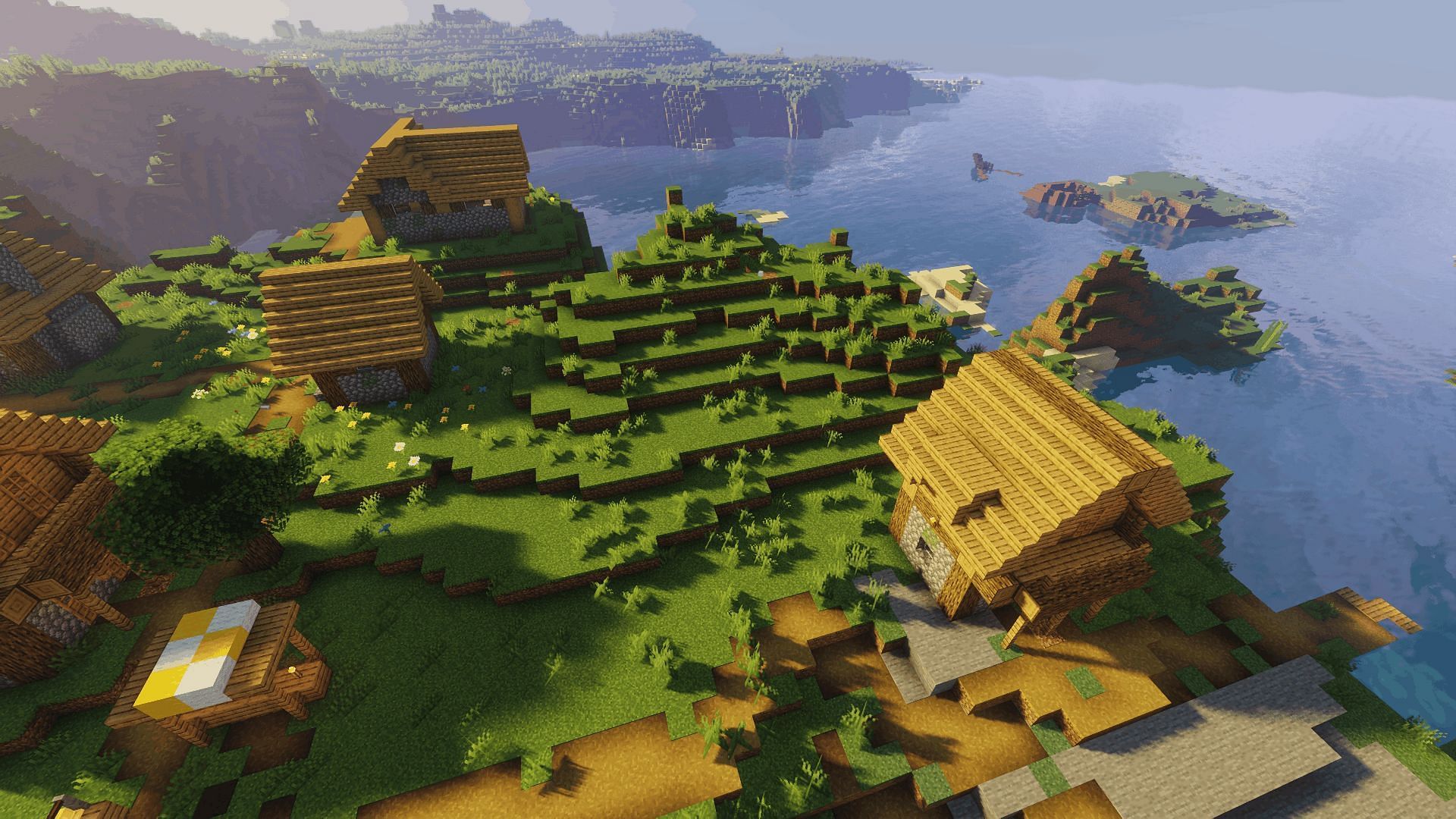 A coastal village with the Sildur&#039;s Vibrant shader (Image via Minecraft)