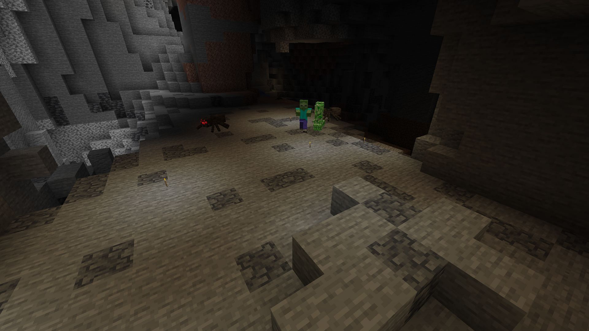 A cave being lit up by torches dropped on the ground (Image via Minecraft)
