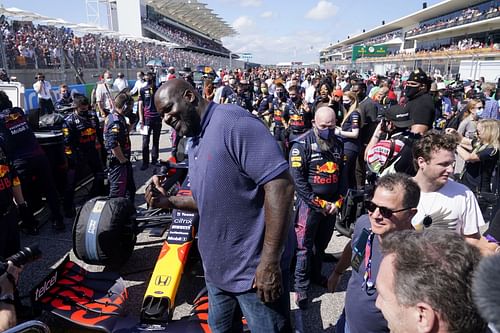 Shaquille O'Neal poses for a photo with the car of Max Verstappen of Netherlands and Red Bull Racing on the grid before the F1 Grand Prix of USA at Circuit of The Americas on October 24, 2021 in Austin, Texas.