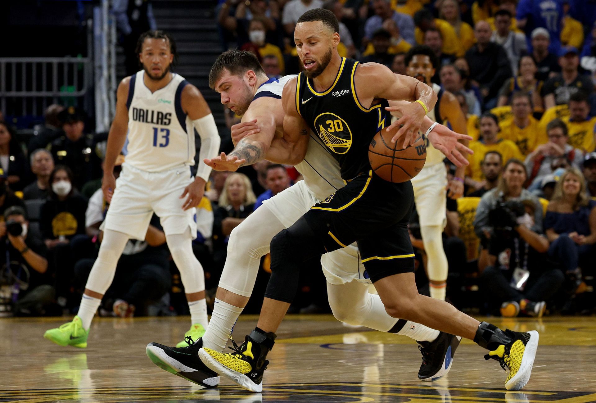 Steph Curry shielding the ball from Luka Doncic in Game One of the Western Conference Finals