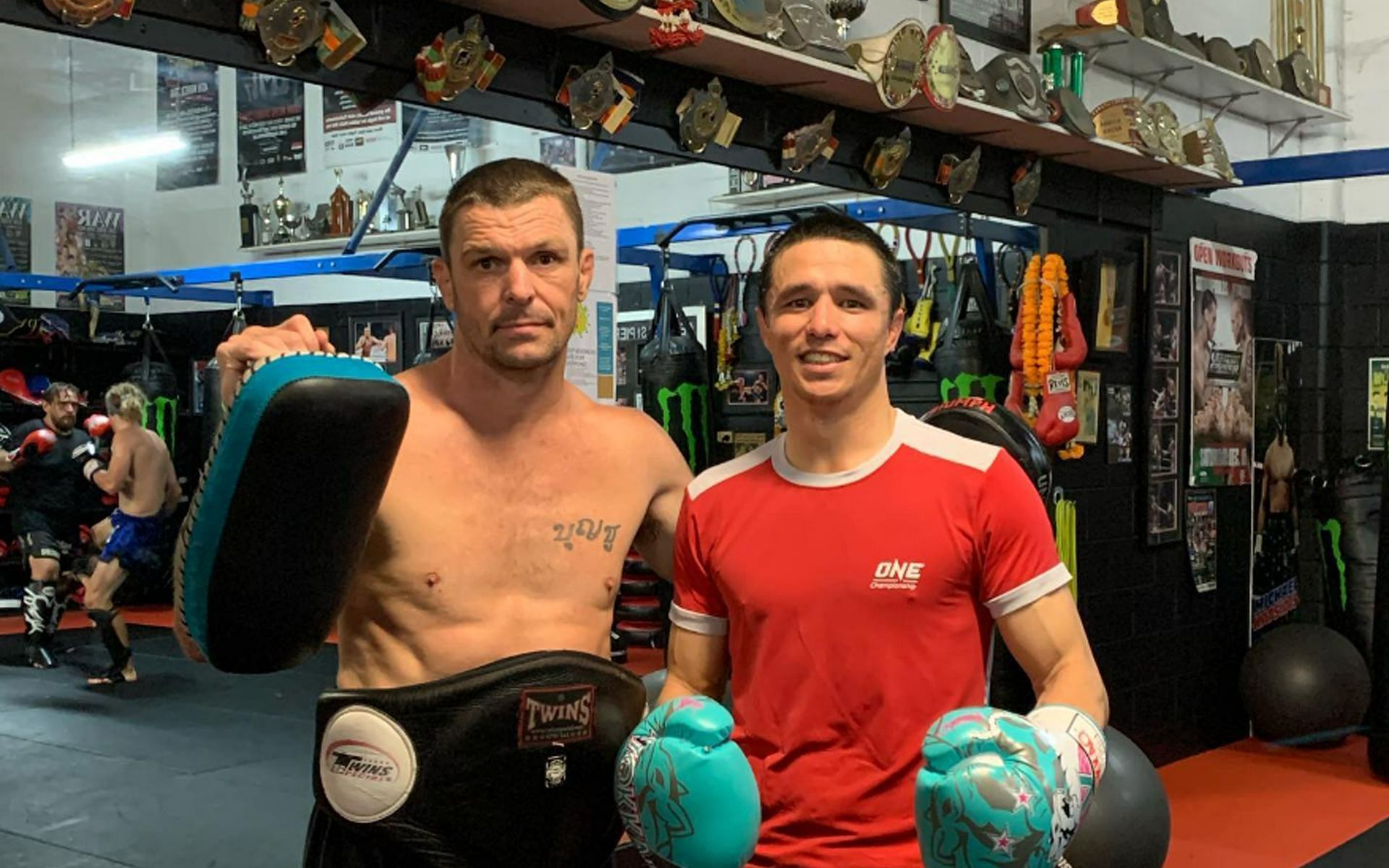 Legendary striker John Wayne Parr (L) now holds the pads for Reece McLaren (R). | [Photo: ONE Championship]