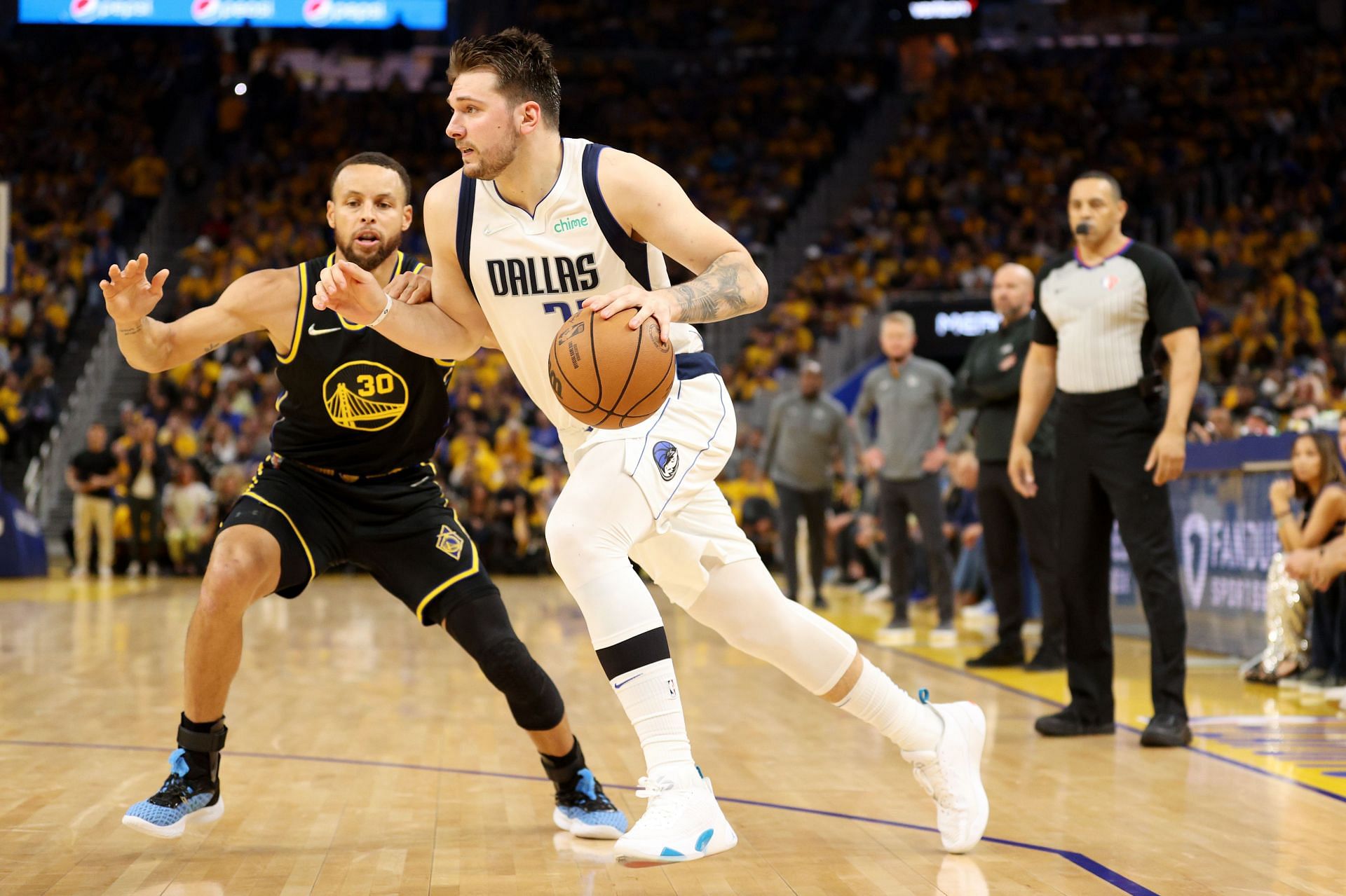 Luka Doncic of the Dallas Mavericks drives against Stephen Curry of the Golden State Warriors.