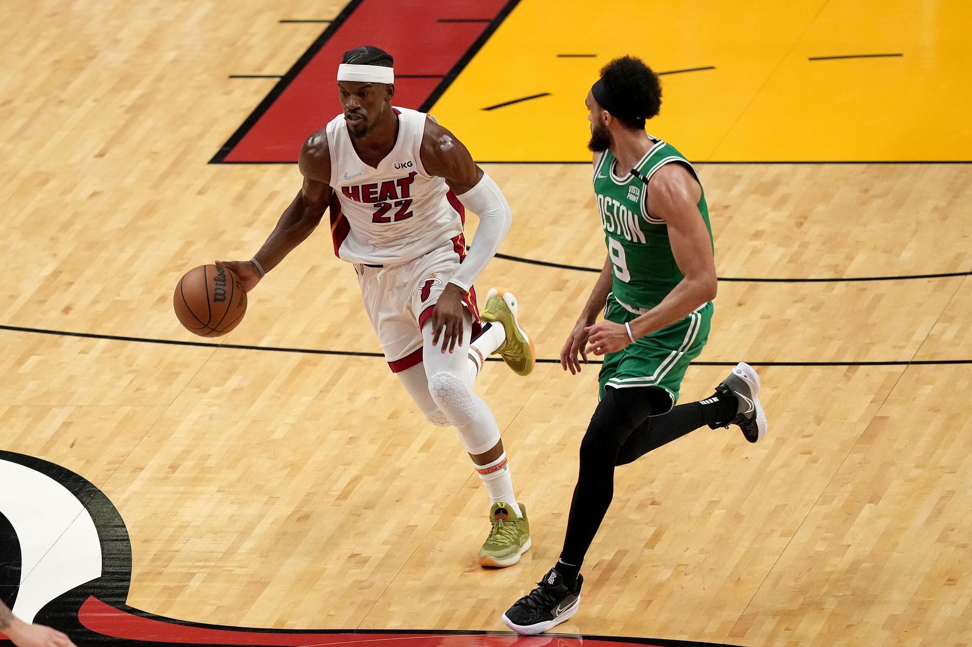 Jimmy Butler of the Miami Heat dribbles against Derrick White of the Boston Celtics.