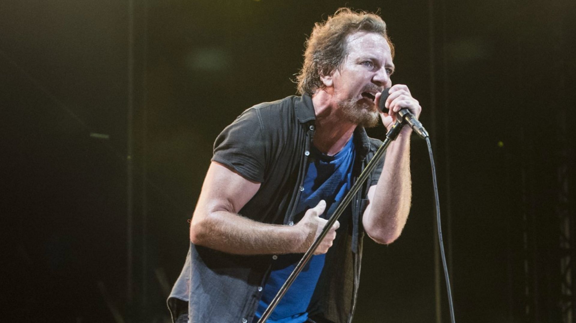 Pearl Jam&#039;s lead vocalist Eddie Vedder performing live (Image via Getty/Jim Bennett)