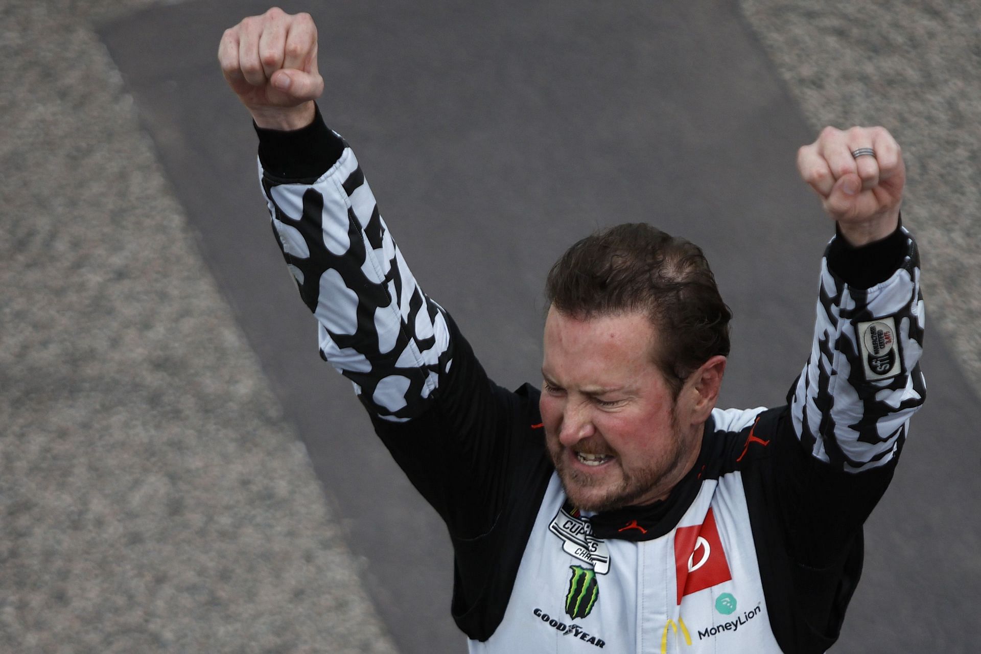 Kurt Busch celebrates after winning the NASCAR Cup Series AdventHealth 400 at Kansas Speedway