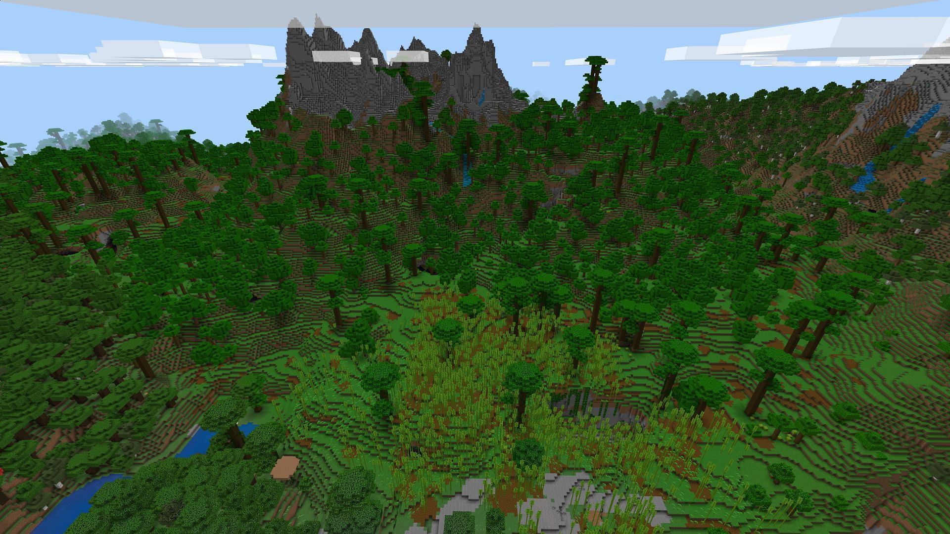 The sprawling jungle with a mountain backdrop and bamboo forest (Image via Minecraft)