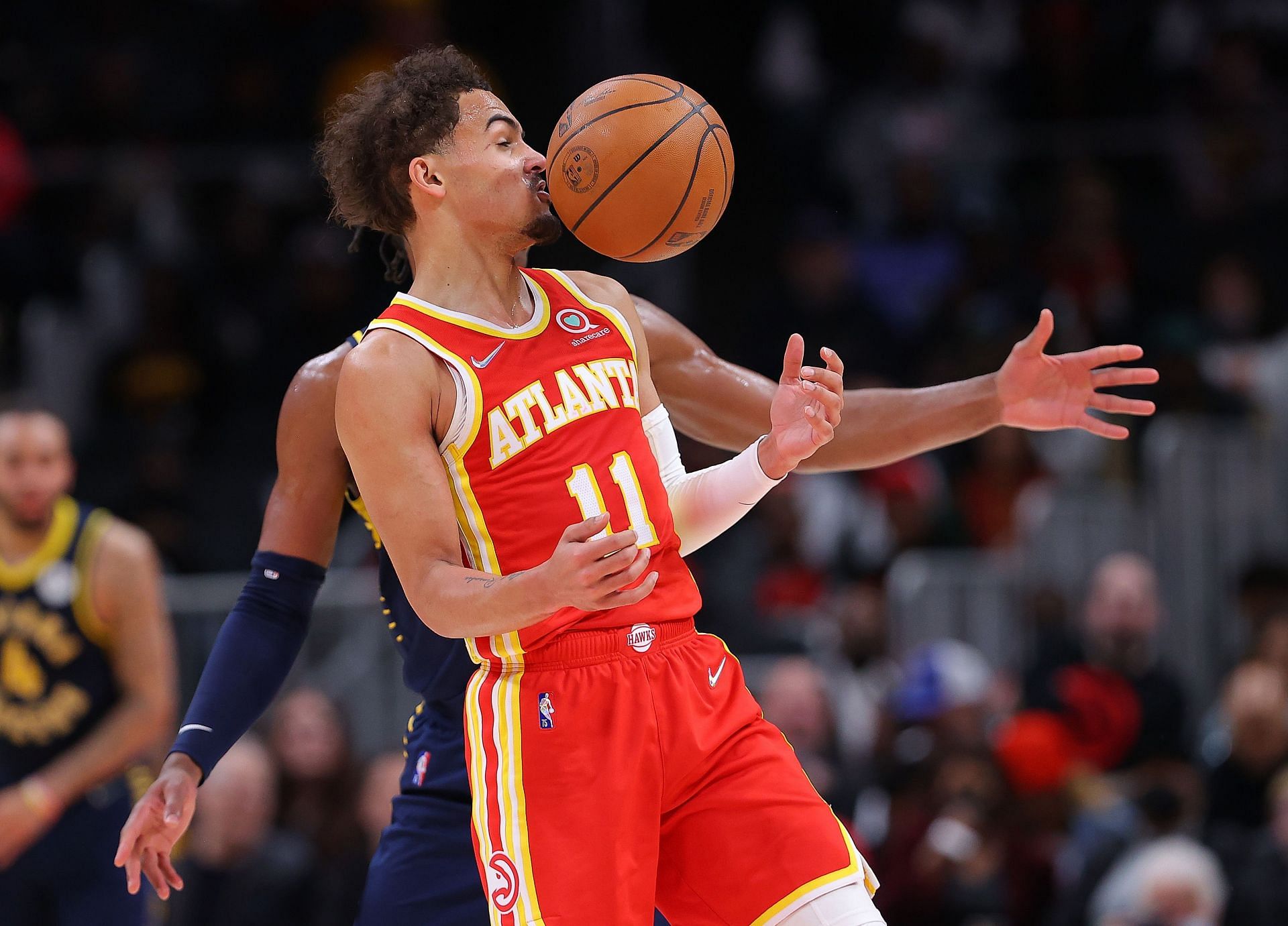 Trae Young of the Atlanta Hawks draws a foul from Buddy Hield of the Indiana Pacers.