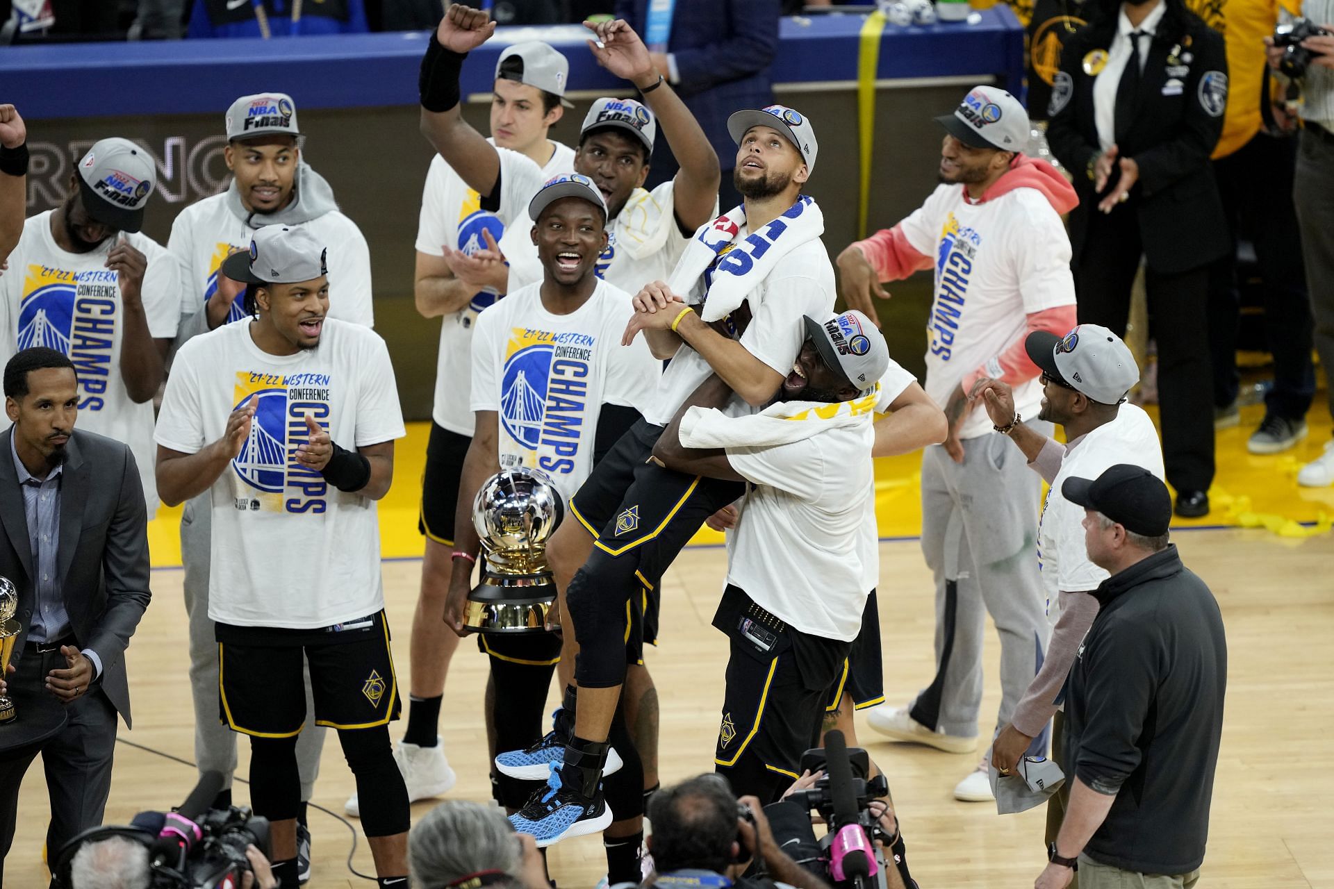 Steph Curry of the Golden State Warriors is lifted up by teammates after winning the Magic Johnson Western Conference finals MVP.