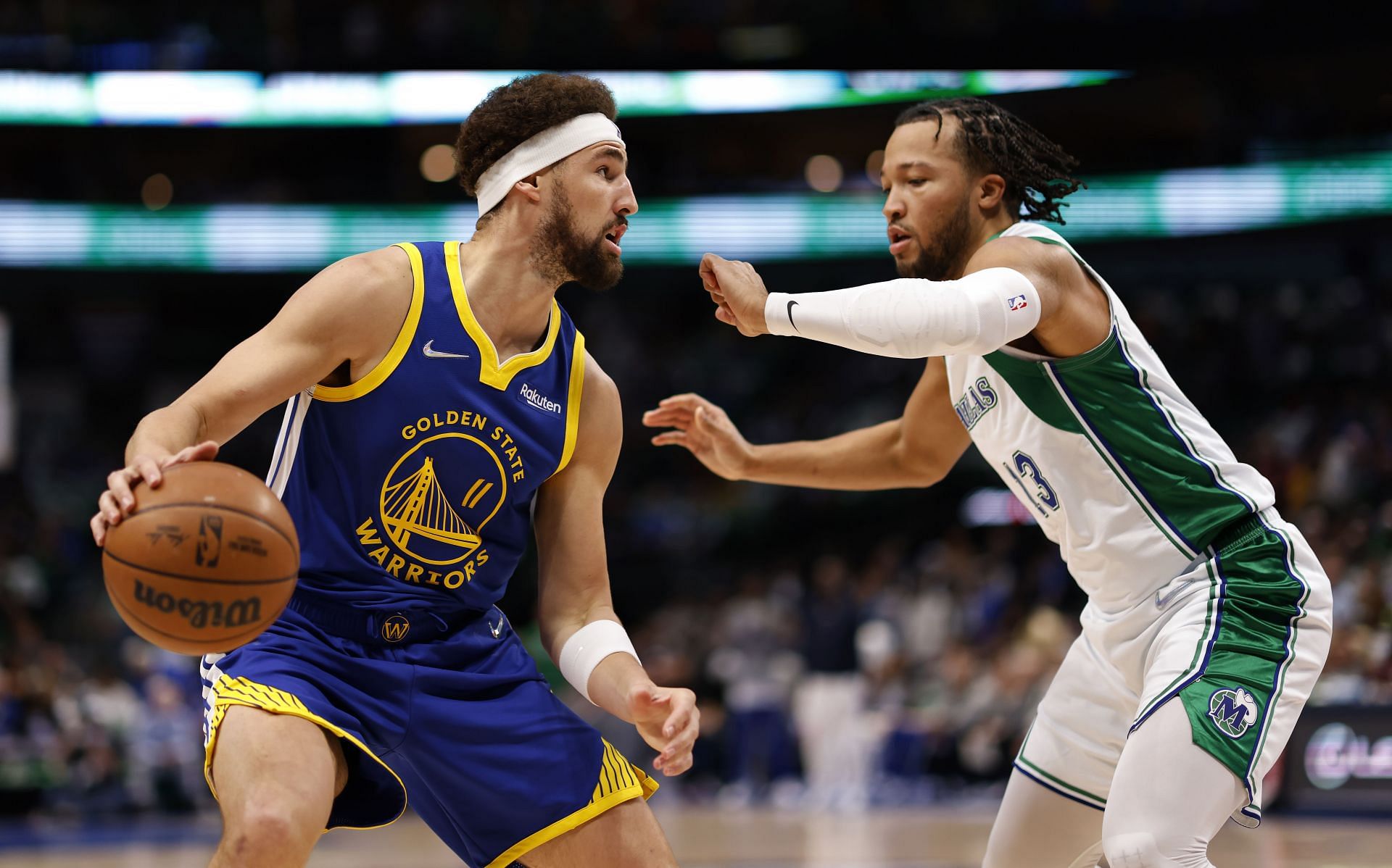 Klay Thompson of the Golden State Warriors handles the ball as Jalen Brunson of the Dallas Mavericks defends.