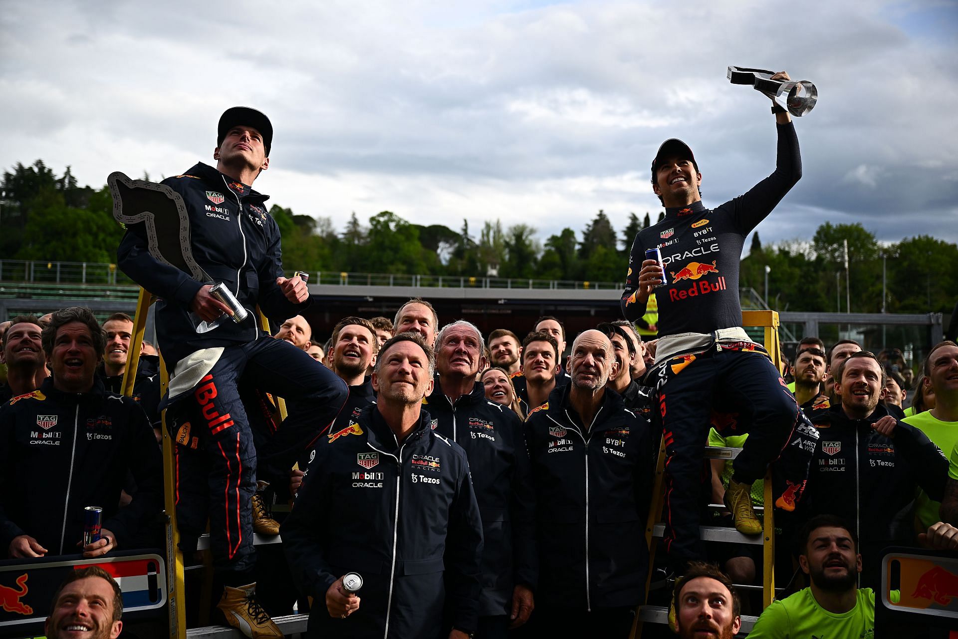 Max Verstappen (left) and Sergio Perez (right) being held aloft by the whole Red Bull team after their one-two finish at the 2022 F1 Imola GP. (Photo by Clive Mason/Getty Images)