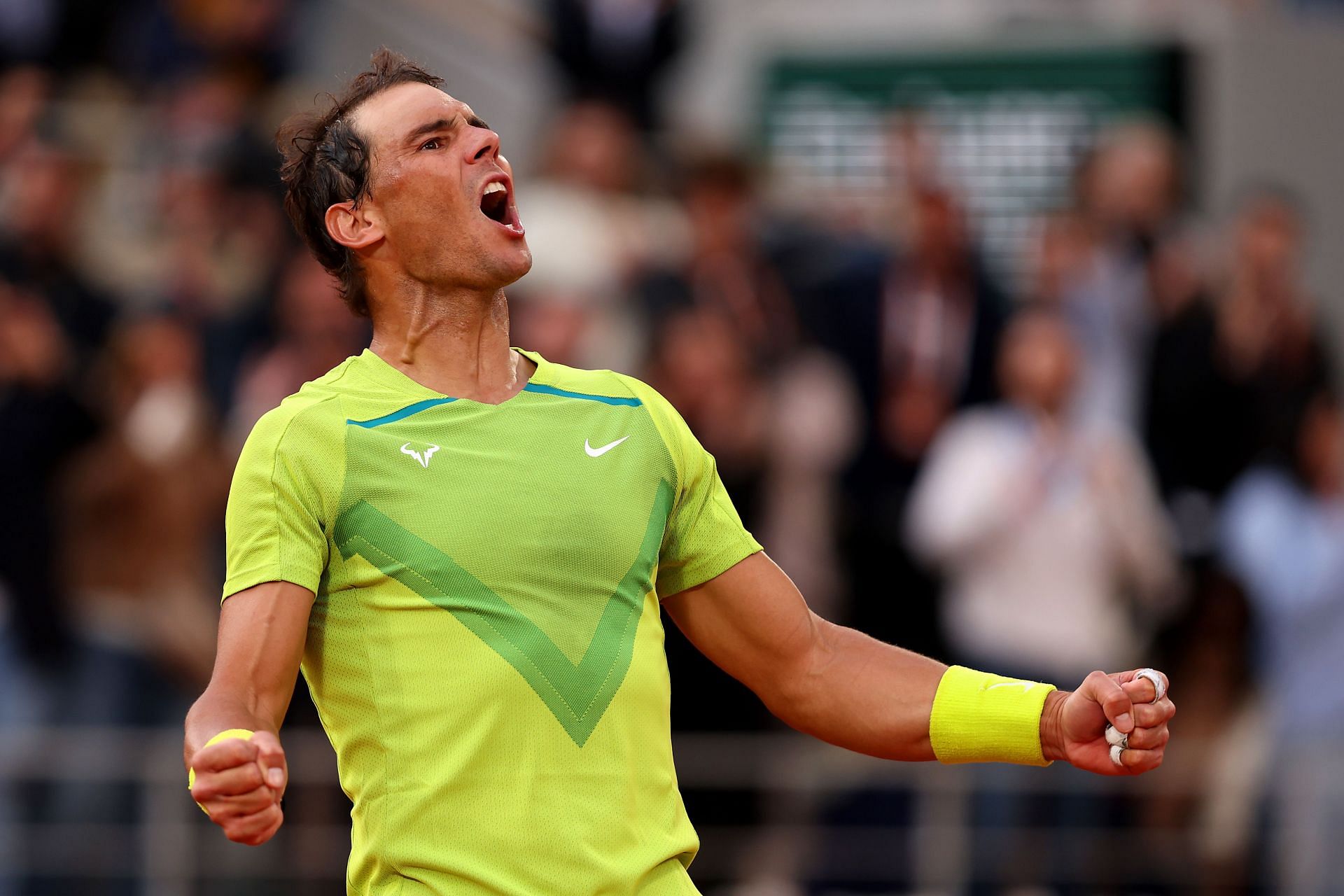 Rafael Nadal lets out a roar as he survives a five-set match for the third time at the French Open
