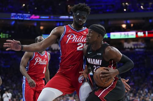 Jimmy Butler drives to the basket against masked Joel Embiid in Game Four