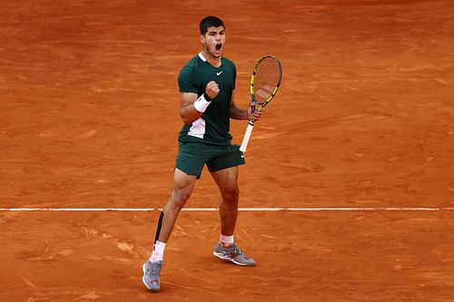 Carlos Alcaraz rejoices after winning a point against Novak Djokovic in Madrid on Saturday