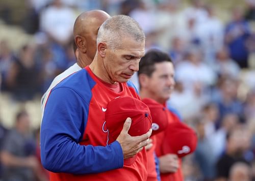 Philadelphia Phillies manager Joe Girardi observing the American national anthem.